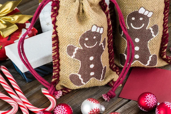 Two glass jars  inside of a burlap bags prepared for Christmas gifts.