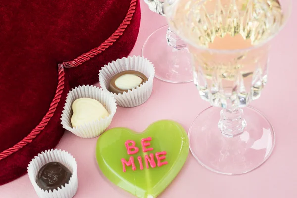 Valentines Day heart shaped candy box and two glasses with wine
