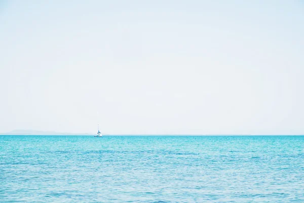 Horizon, blue ocean and clear sky with sailing boat, vintage tone soft focus