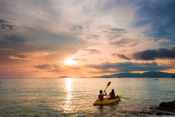 Couple kayaking in sunset, holiday vacation summer times, dating, romantic, romantic, vintage tone