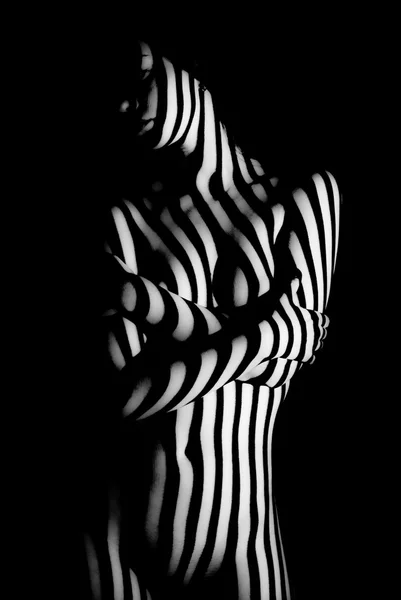 Stripes of light on naked body