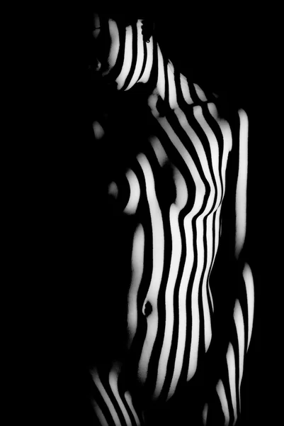 Stripes of light on naked body