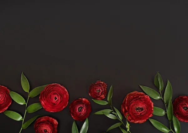 Red elegant flowers at black table