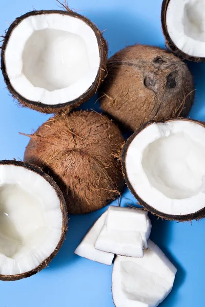 Coconuts on bright blue table