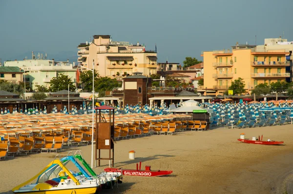 Travel beach Romagna - beach and sea in Rimini with yellow umbrellas and red rescue boat