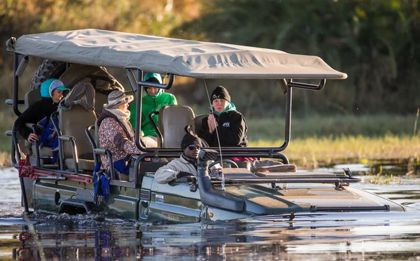 People on boat on trees background