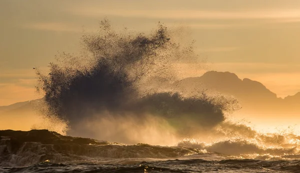 Waves crashing on rocky seashore