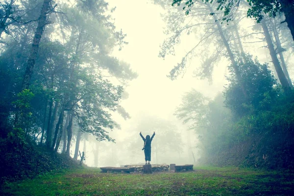 Happy person in the foggy forest