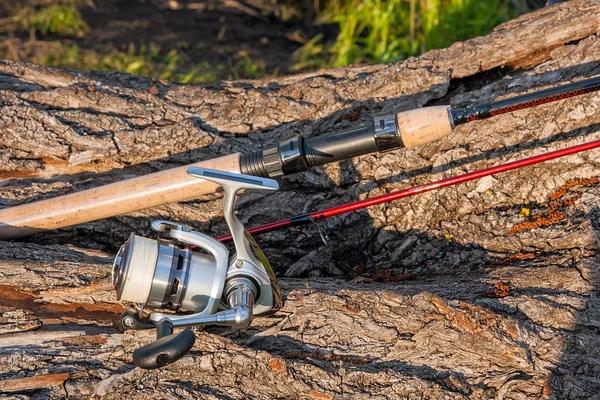 Fishing rod and reel on the natural background.