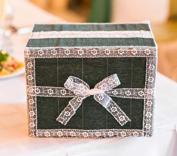 Gift box on white table.