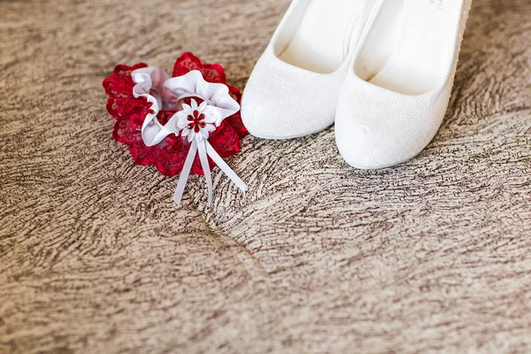 Brides shoes and red wedding garter