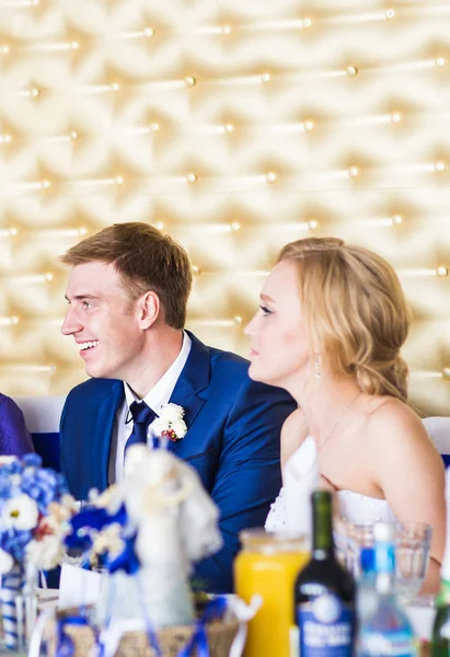 Emotional beautiful newlywed couple smiling at wedding reception