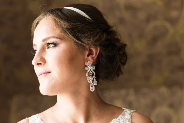 Close up of beautiful woman wearing shiny diamond earrings