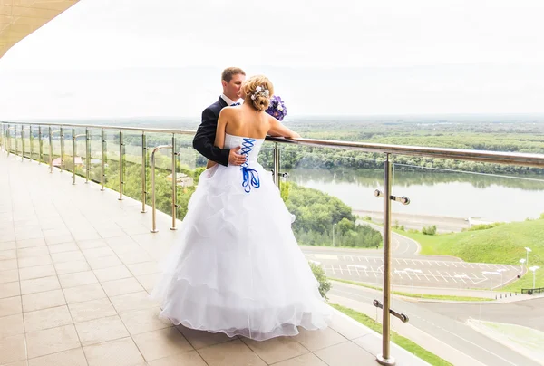 Handsome brunette groom kissing beautiful bride in wedding dress