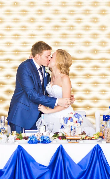 Handsome brunette groom kissing beautiful bride in wedding dress