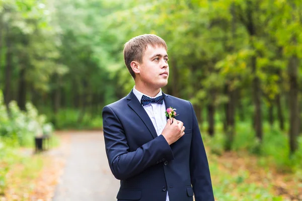 Sexy man in tuxedo and bow tie posing