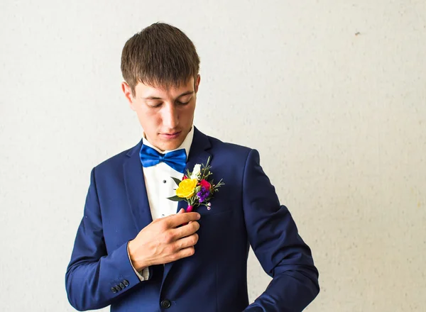 Wonderful wedding boutonniere on a costume of groom