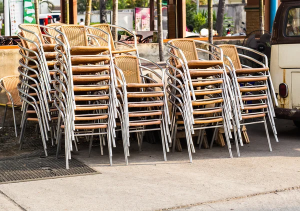 Groups of chairs stacked and chained together outdoors