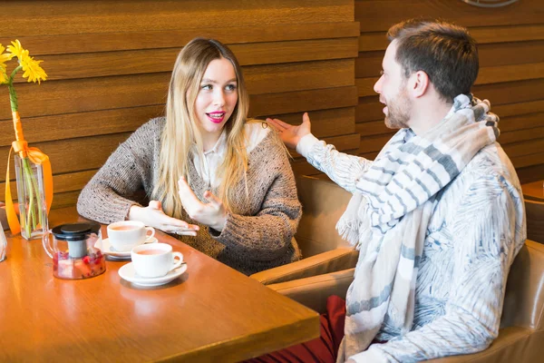 Young couple have interesting discussion in cafe