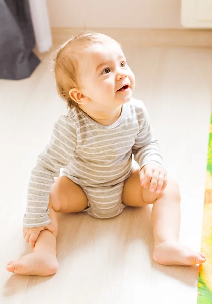 Baby boy plays in his room.