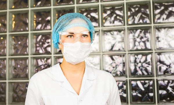 Science, biology, ecology, research and people concept - close up of young female scientist wearing protective mask in bio laboratory