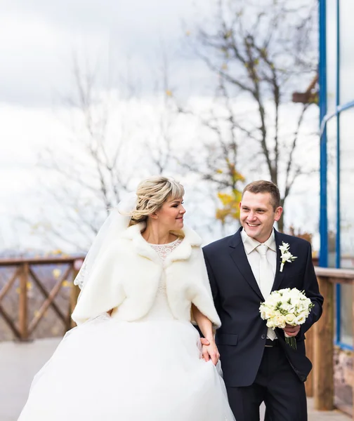 Happy couple in winter or autumn wedding day