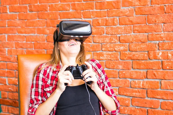 Woman play video game with joystick and VR device