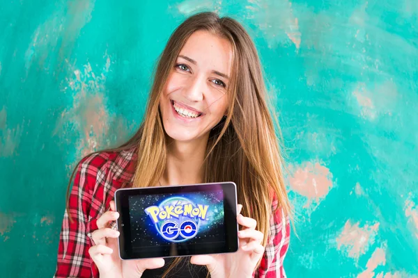 Ufa, Russia. - July 29: Woman show the tablet with Pokemon Go logo, July 29, 2016 in Ufa, Russia