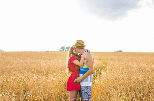 Stunning sensual portrait of young stylish fashion man and woman posing in field