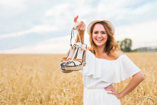 Excited woman holding new shoes that she found on sale