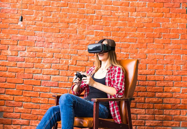 Woman play video game with joystick and VR device