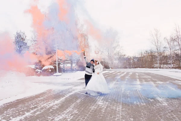 Bride and groom have fun on their winter wedding