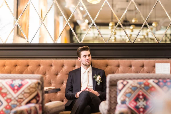 Handsome man sitting in luxury chair