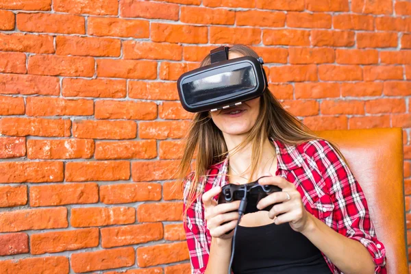 Woman play video game with joystick and VR device