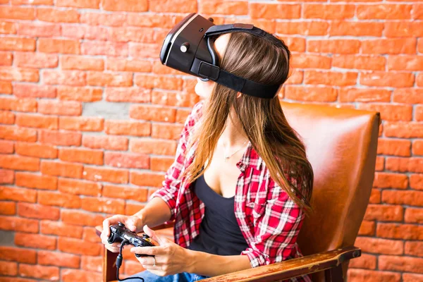 Woman play video game with joystick and VR device