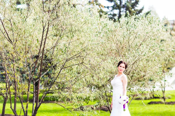 Beautiful bride in wedding dress and bridal bouquet