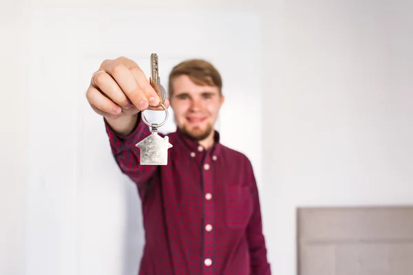 Holding out house keys. Housewarming