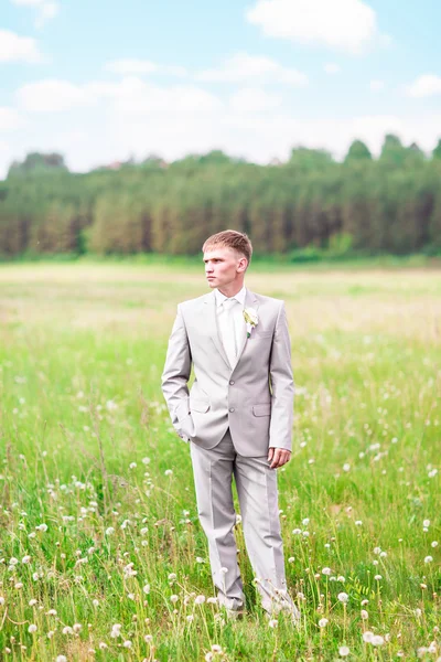 Portrait of the groom with boutonniere outdoors on their wedding day