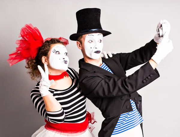 Funny couple of mimes taking a selfie photo