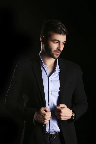 Casual young man model in a black background