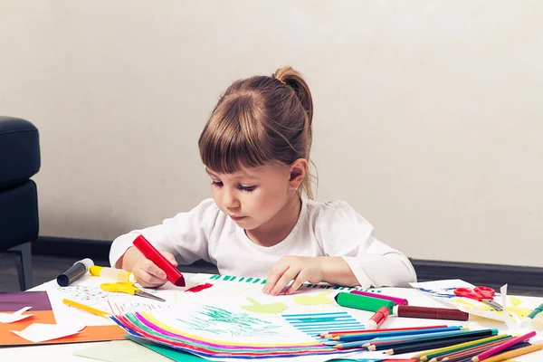 Beautiful little girl draws felt-tip pens