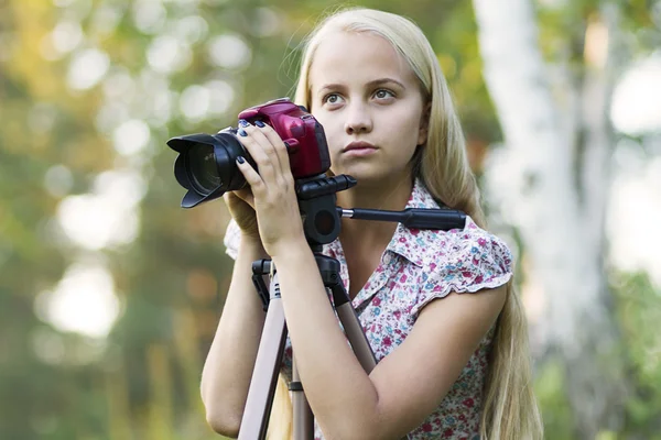 Young woman photographer in a forest