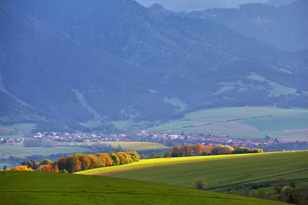 Town and green spring hills in Slovakia. May sunny countryside