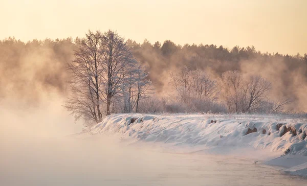 Winter dawn. Winter foggy sunrise on the river.Winter morning mi