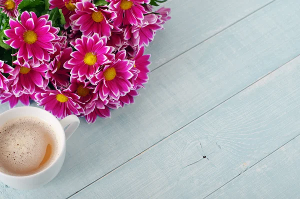 Bouquet of beautiful flowers with cup of coffee