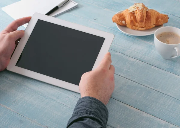 Man holding tablet computer with a blank screen