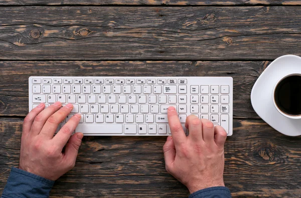 Man typing on a wireless computer keyboard