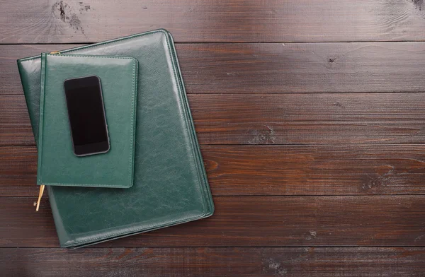 Smartphone With Blank Screen And Green Leather Business Folders
