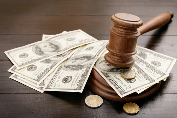 Judge gavel with dollars and euro cents