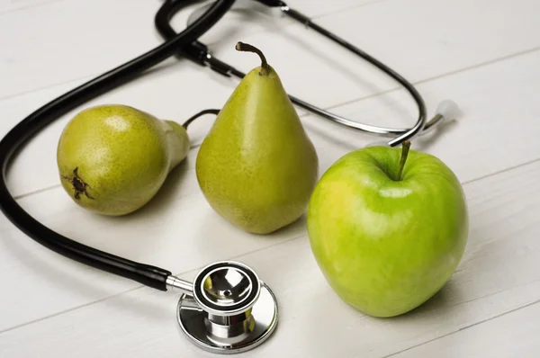 Fruits (apples and pears) with stethoscope